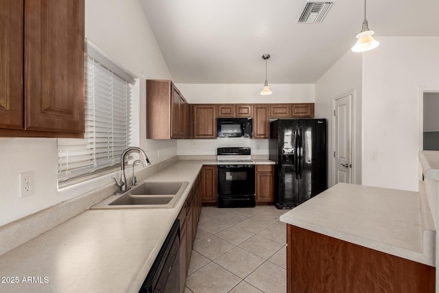 kitchen with decorative light fixtures, sink, light tile patterned floors, and black appliances