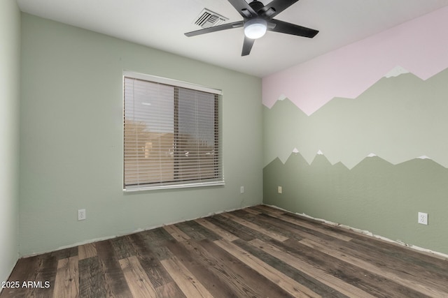 spare room featuring ceiling fan and dark hardwood / wood-style flooring