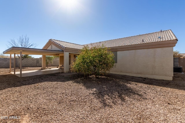 back of property with a patio