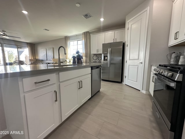 kitchen featuring appliances with stainless steel finishes, a healthy amount of sunlight, visible vents, and a sink