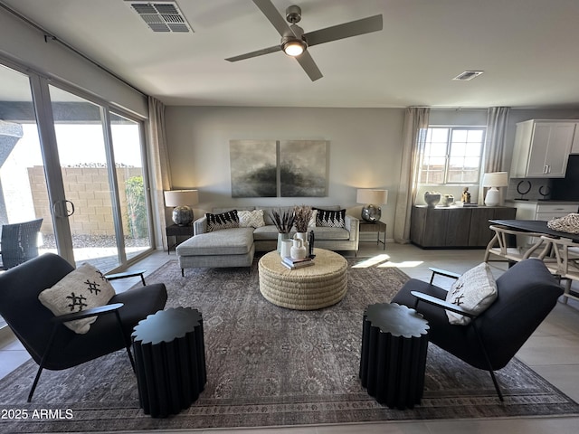 living room with visible vents and ceiling fan