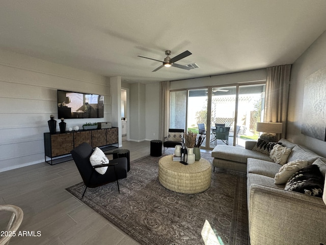 living room with visible vents, ceiling fan, and wood finished floors