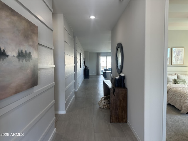 hall featuring recessed lighting and baseboards