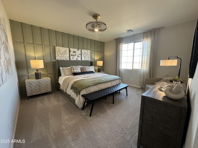 carpeted bedroom featuring visible vents and baseboards