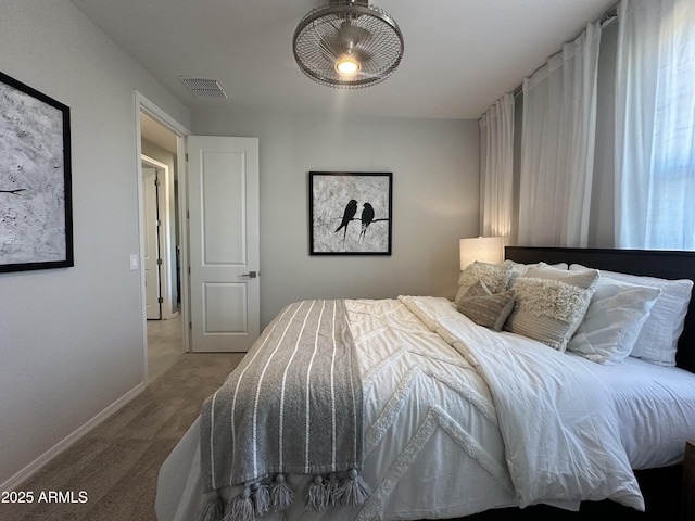 carpeted bedroom with baseboards and visible vents