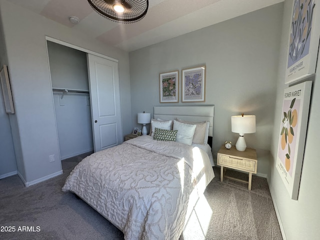 carpeted bedroom featuring baseboards and a closet