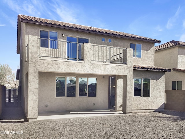 back of house with a balcony and a patio area