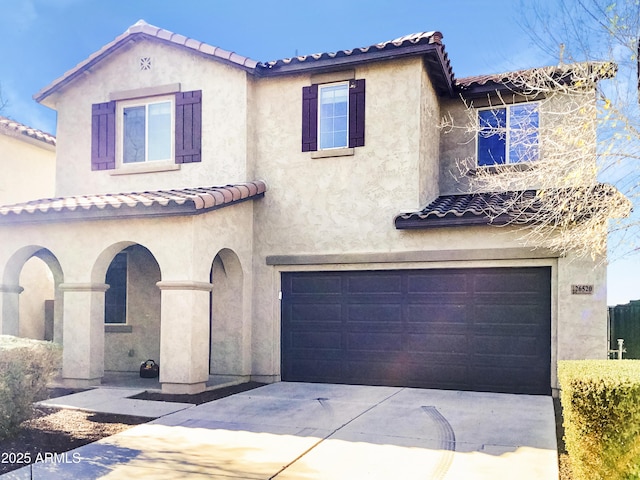 mediterranean / spanish-style house with a garage