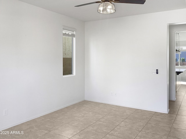 unfurnished room featuring ceiling fan, plenty of natural light, and light tile patterned floors