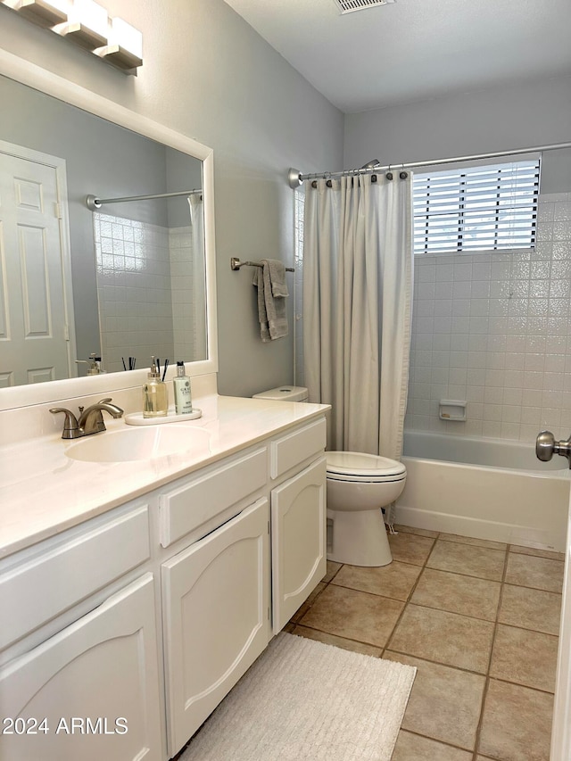 full bathroom featuring toilet, vanity, tile patterned floors, and shower / bathtub combination with curtain