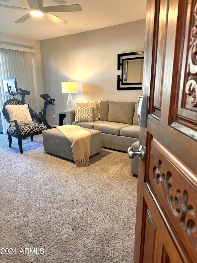 carpeted living room with ceiling fan