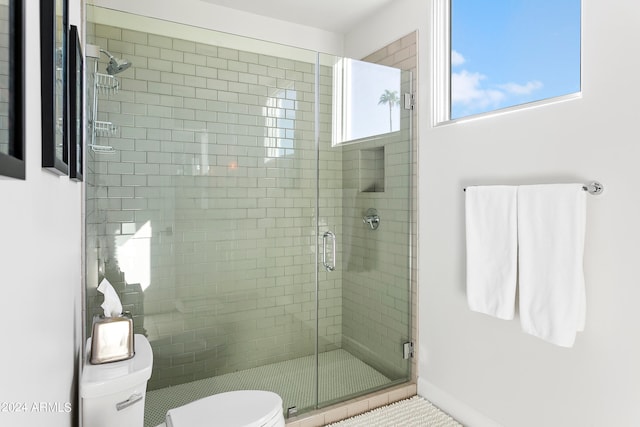 bathroom with tile patterned flooring, toilet, and walk in shower