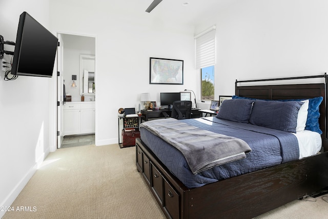 carpeted bedroom featuring ensuite bathroom and ceiling fan