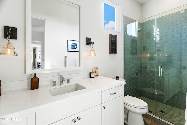 bathroom featuring toilet, an enclosed shower, vanity, and tile patterned flooring