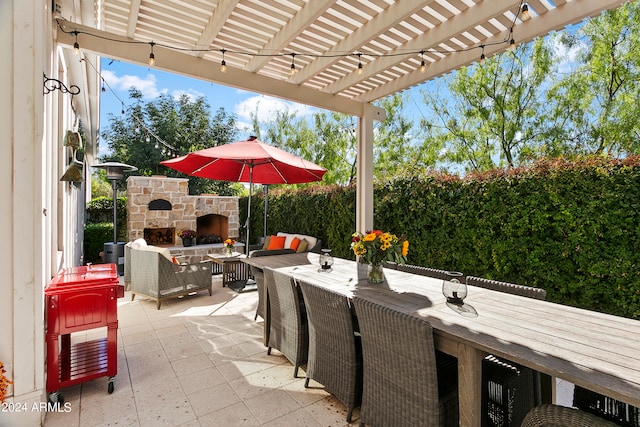 view of patio / terrace with a pergola and an outdoor living space with a fireplace