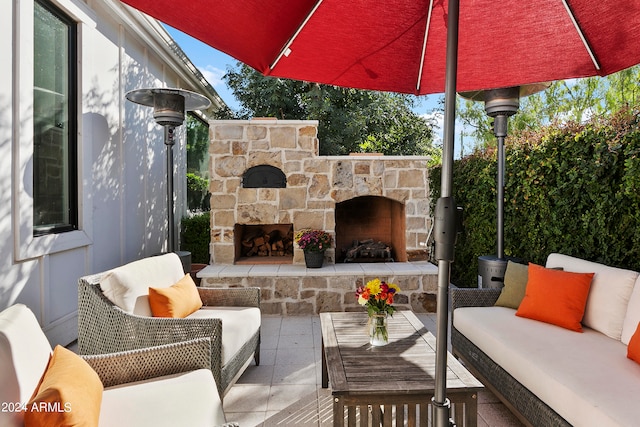 view of patio / terrace featuring an outdoor living space with a fireplace