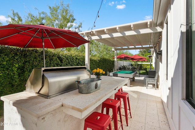 view of patio featuring an outdoor bar and a pergola