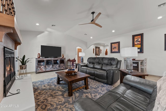 living room with ceiling fan and vaulted ceiling