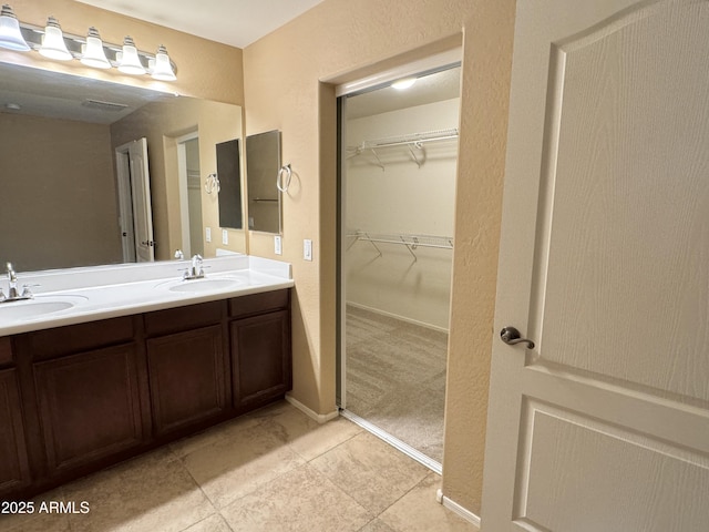 bathroom with tile patterned flooring and vanity