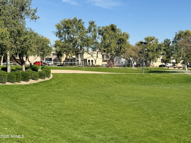 surrounding community featuring volleyball court and a yard