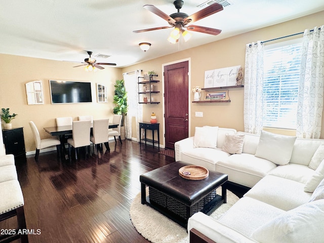 living room with ceiling fan and dark hardwood / wood-style flooring