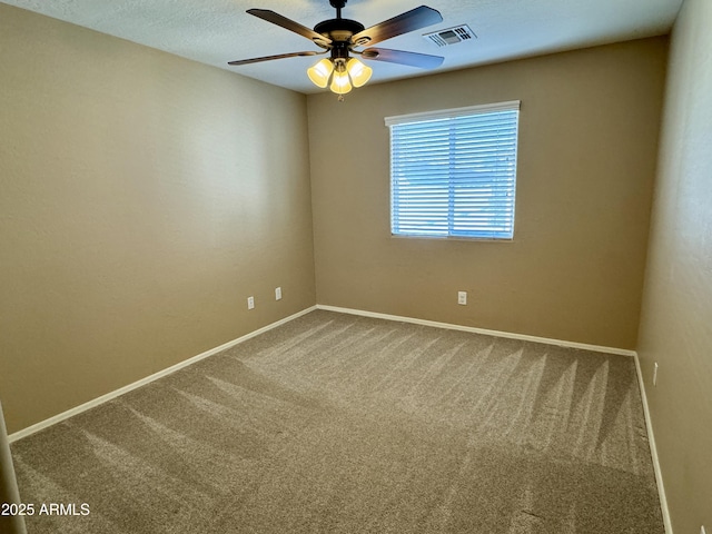 carpeted spare room with ceiling fan