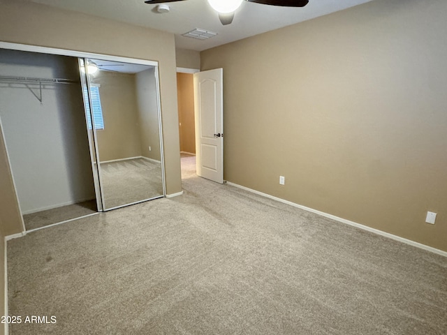 unfurnished bedroom with ceiling fan, a closet, and light carpet