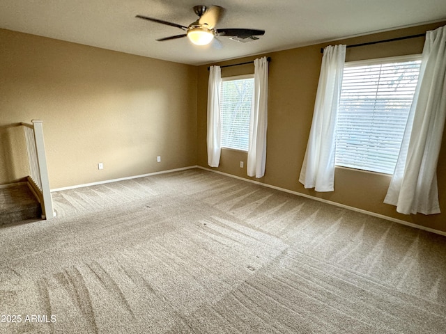 empty room featuring carpet floors and ceiling fan