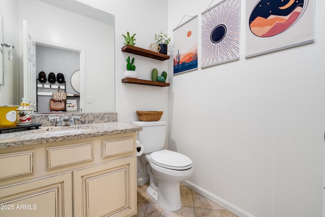 bathroom with vanity, tile patterned floors, and toilet