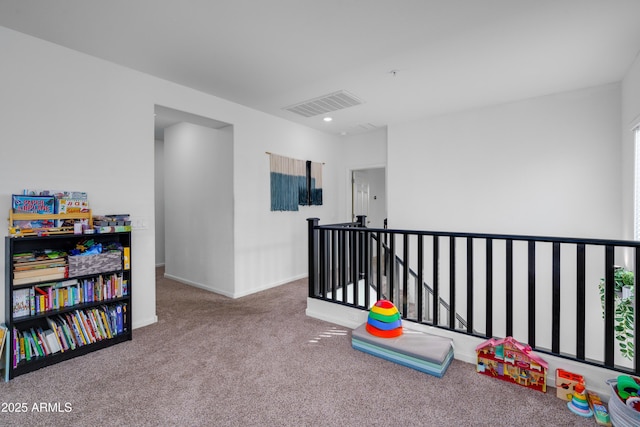 recreation room with carpet flooring