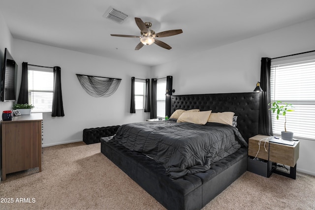 carpeted bedroom featuring ceiling fan and multiple windows