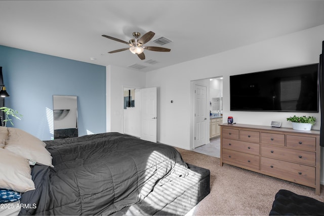 carpeted bedroom with connected bathroom and ceiling fan