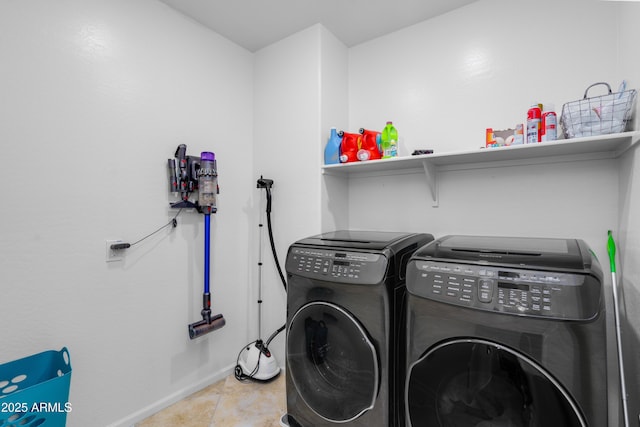 washroom featuring light tile patterned flooring and washing machine and clothes dryer