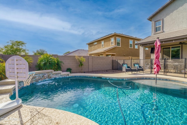 view of swimming pool with pool water feature and a patio area