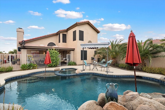 view of pool featuring an in ground hot tub and a patio