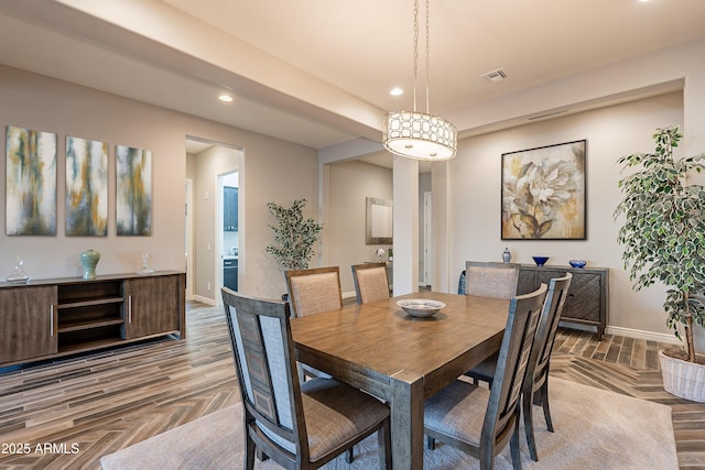 dining area featuring parquet flooring