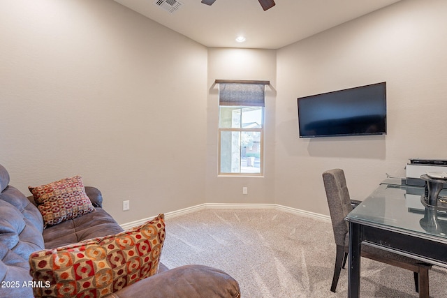 carpeted office space featuring ceiling fan