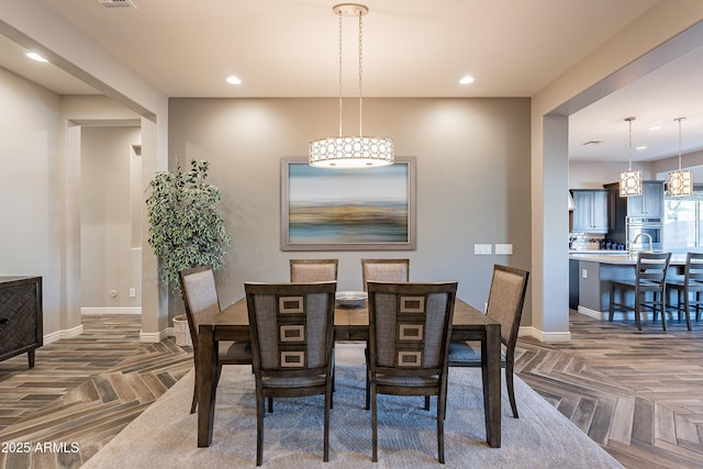 dining space with parquet flooring