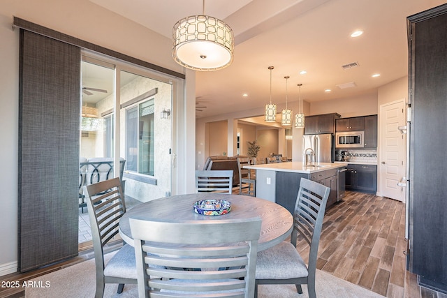 dining area featuring dark hardwood / wood-style floors and sink