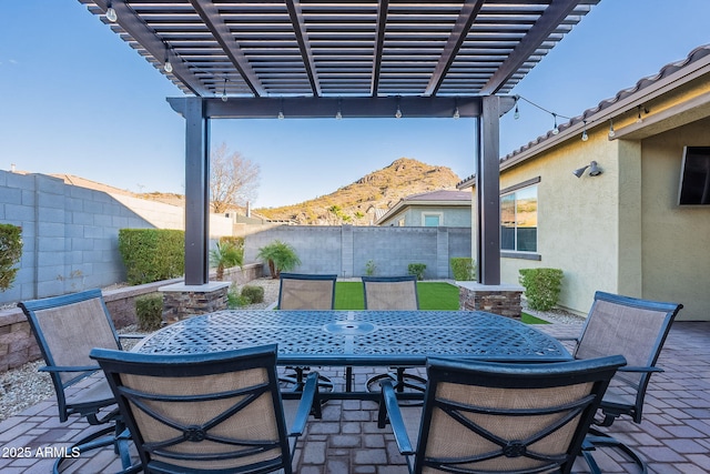 view of patio with a pergola and a mountain view