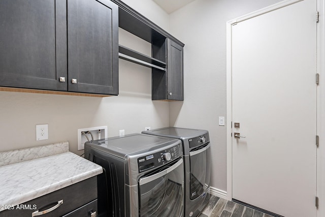 laundry area featuring cabinets, dark hardwood / wood-style floors, and independent washer and dryer