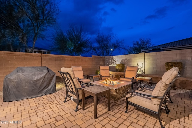 view of patio with a grill and an outdoor fire pit