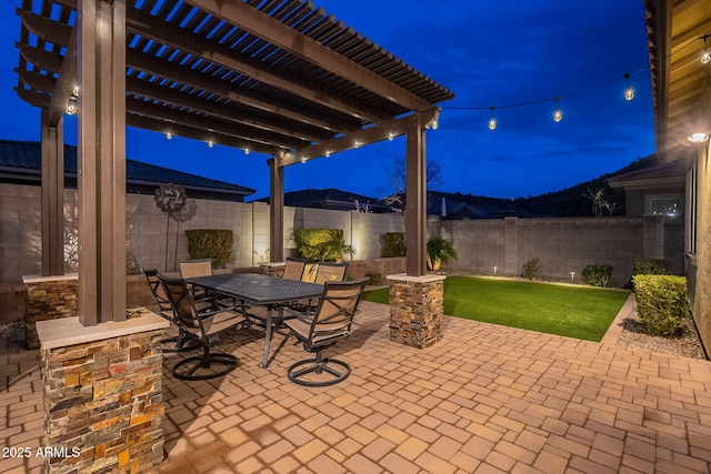 patio at twilight featuring a pergola