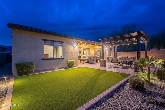 rear view of house featuring a pergola, a yard, and a patio area