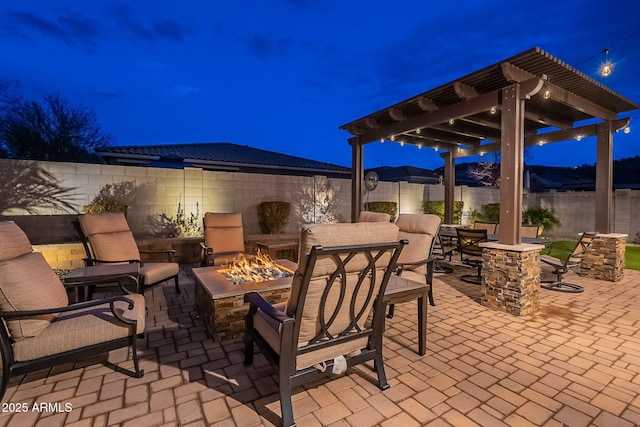 patio at twilight with an outdoor fire pit and a pergola