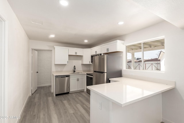 11842 N 30th Dr, Phoenix, AZ 85029 - kitchen featuring a peninsula, light countertops, white cabinets, stainless steel appliances, and a sink