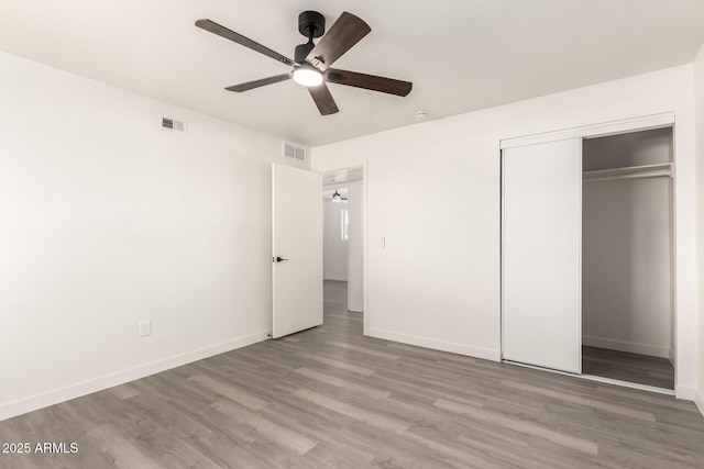 11842 N 30th Dr, Phoenix, AZ 85029 - unfurnished bedroom featuring visible vents, baseboards, a closet, and wood finished floors