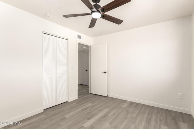 11842 N 30th Dr, Phoenix, AZ 85029 - unfurnished bedroom with light wood-style flooring, a closet, and baseboards
