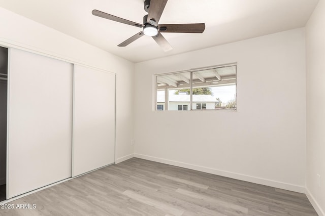 11842 N 30th Dr, Phoenix, AZ 85029 - unfurnished bedroom featuring a closet, baseboards, light wood finished floors, and a ceiling fan