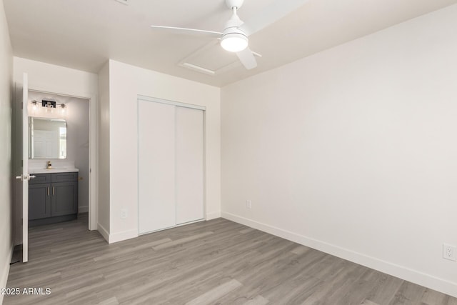 11842 N 30th Dr, Phoenix, AZ 85029 - unfurnished bedroom featuring light wood-style floors, ceiling fan, a closet, a sink, and baseboards
